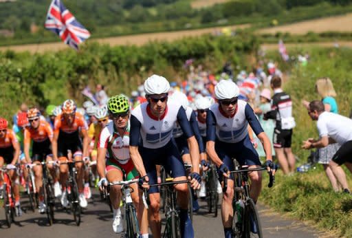 Bradley Wiggins of Great Britain (C) rides next to compatriot Chris Froome (R) during the men's road cycling race on day 1 of the London 2012 Olympic Games in London