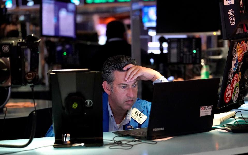 Traders work on the floor at the New York Stock Exchange in New York, on July 29, 2021. - Wall Street stocks climbed early July 29 following another round of mostly strong earnings and US data that showed strong second-quarter growth that lagged expectations. (Photo by TIMOTHY A. CLARY / AFP) (Photo by TIMOTHY A. CLARY/AFP via Getty Images)