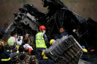 <p>Rescue workers work at the wreckage of a US-Bangla airplane after it crashed at the Tribhuvan International Airport in Kathmandu, Nepal, March 12, 2018. (Photo: Navesh Chitrakar/Reuters) </p>