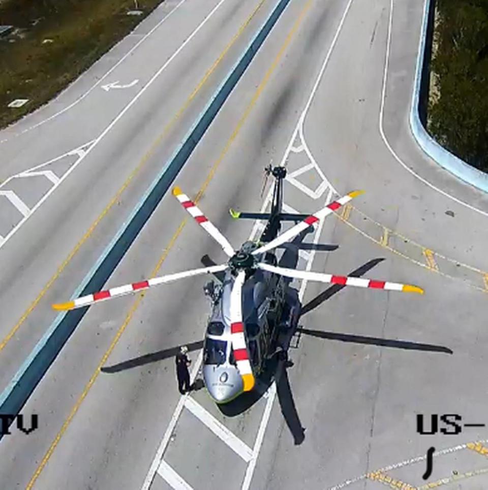 A Miami-Dade County Fire Rescue helicopter ambulance lands at mile marker 109 of the 18 Mile Stretch of U.S. 1 near Key Largo to pick up a person injured in a boating accident Thursday, March 30, 2023.