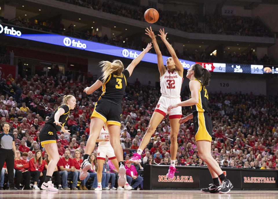 Nebraska's Kendall Coley (32) shoots against Iowa's Sydney Affolter (3) during the first half of an NCAA college basketball game Sunday, Feb. 11, 2024, in Lincoln, Neb. (AP Photo/Rebecca S. Gratz)