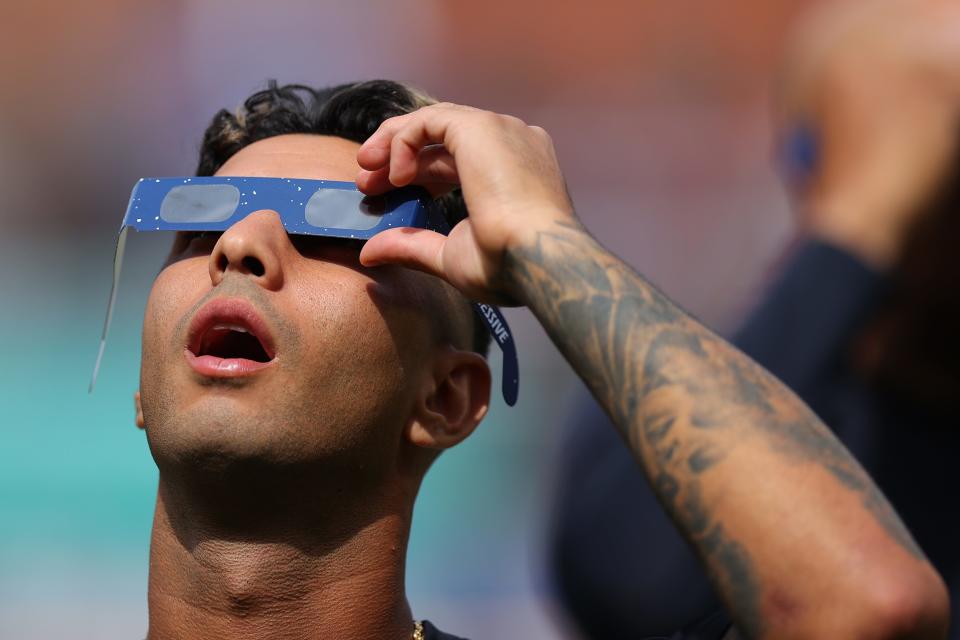 Brayan Rocchio #4 of the Cleveland Guardians looks up at the total solar eclipse before the home opener against the Chicago White Sox at Progressive Field on April 8, 2024 in Cleveland, Ohio.