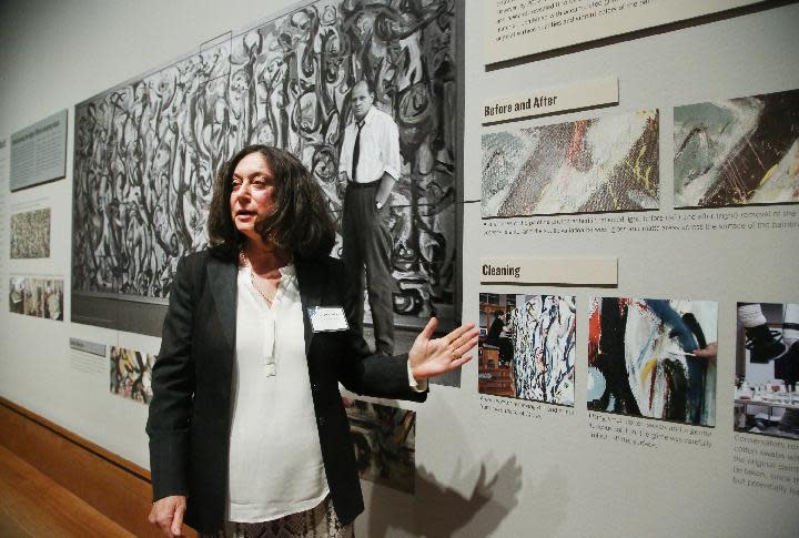 Yvonne Szafran, head of paintings conservation at the Getty Museum comments on the conservation treatment of Jackson Pollock's “Mural,” 1943, during a media preview at the J. Paul Getty Museum in Los Angeles on Monday, March 10, 2014. The oil-on-canvas work, measuring more than 8 feet high and nearly 20 feet long, has been under wraps at the J. Paul Getty Museum for more than a year undergoing extensive restoration. The painting, owned by the University of Iowa, will be on display at The J. Paul Getty Museum for three months, from March 11 to June 1, 2014 at the Getty Center. (AP Photo/Nick Ut )