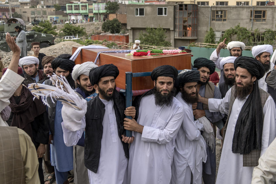 Mourners carry the body of a victim of a mosque bombing in Kabul, Afghanistan, Thursday, Aug. 18. 2022. A bombing at a mosque in Kabul during evening prayers on Wednesday killed at least 10 people, including a prominent cleric, and wounded over two dozen, an eyewitness and police said. (AP Photo/Ebrahim Noroozi)