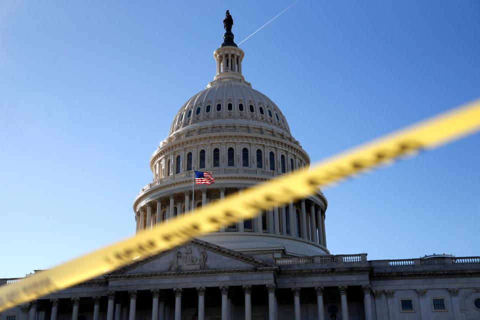 Police tape marks a secured area of the Capitol, Friday, Jan. 19, 2018, in Washington, as a bitterly divided Congress hurtles toward a government shutdown this weekend.