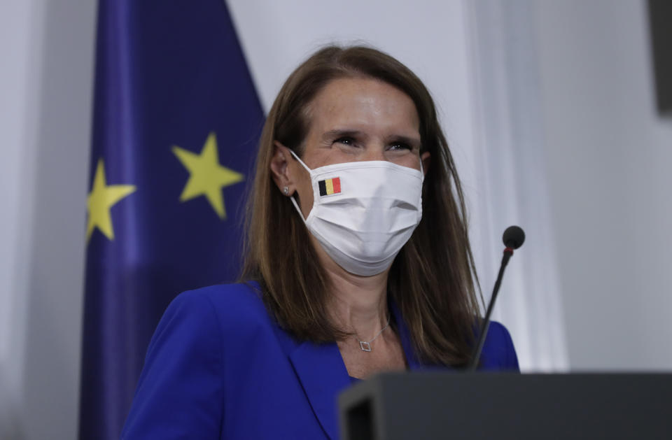 Belgian Prime Minister Sophie Wilmes, wearing a protective mask, prepares to address a press conference following the National Security Council meeting on the COVID-19 outbreak, in Brussels, Wednesday, Sept. 23, 2020. Belgium's prime minister announced Wednesday a relaxation of social-distancing rules as part of a less stringent long-term coronavirus strategy, despite the steady rise of COVID-19 cases in a country already hard-hit by the virus. (Olivier Hoslet, Pool via AP)