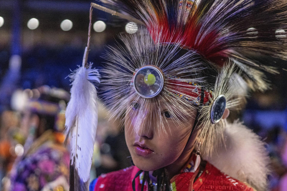 Eleven year-old Wakinyan Snow of Alberta, Canada prepares to dance in the Jr. Boys Traditional competition at the 40th anniversary of the Gathering of Nations Pow Wow in Albuquerque, N.M., Friday, April 28, 2023. Tens of thousands of people gathered in New Mexico on Friday for what organizers bill as the largest powwow in North America. (AP Photo/Roberto E. Rosales)