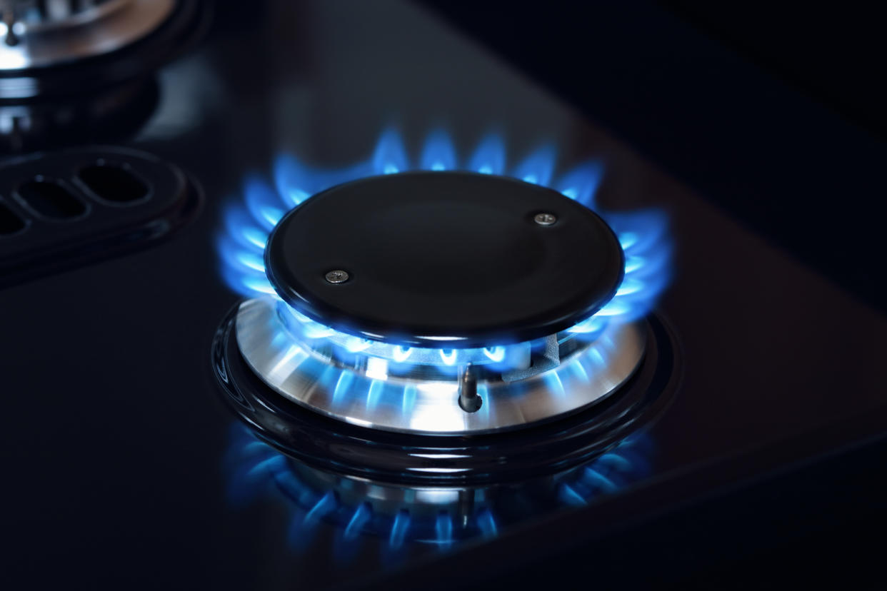 Natural gas burner flame on black stove