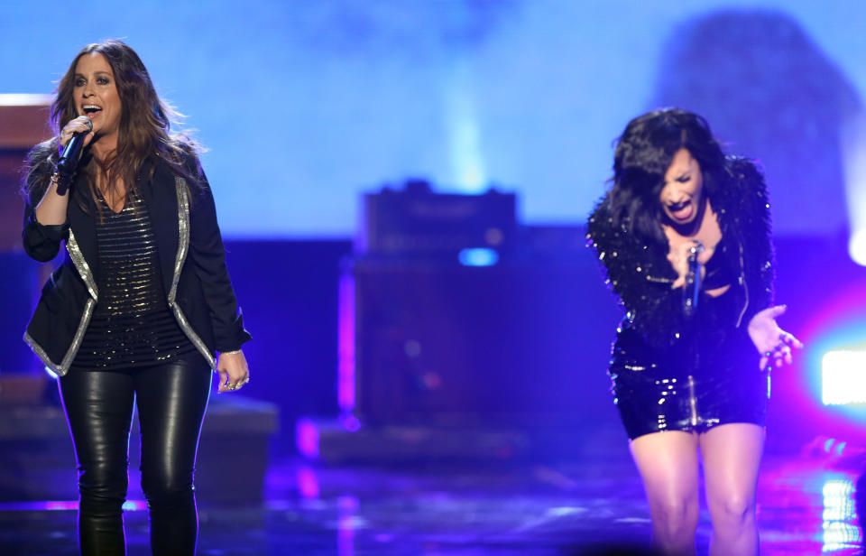 Alanis Morissette, left, and Demi Lovato perform at the American Music Awards at the Microsoft Theater on Sunday, Nov. 22, 2015, in Los Angeles. (Photo by Matt Sayles/Invision/AP)