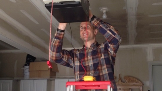 man installing garage door opener