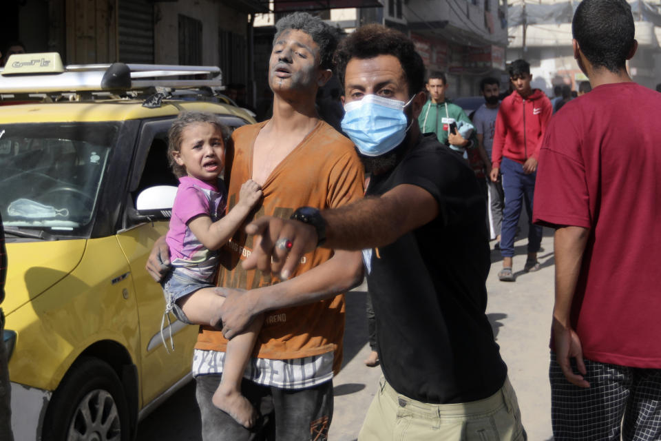 Injured Palestinians are evacuated following Israeli airstrikes on town of Khan Younis, southern Gaza Strip, Thursday, Oct. 26, 2023. (AP Photo/Mohammed Dahman)