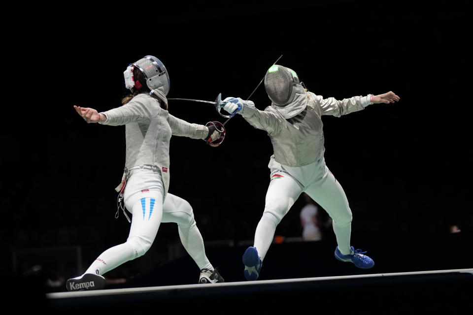 Maria Belen Perez Maurice of Argentina, left, and Anna Marton of Hungary compete in the women's individual round of 32 Sabre competition at the 2020 Summer Olympics, Monday, July 26, 2021, in Chiba, Japan. (AP Photo/Hassan Ammar)