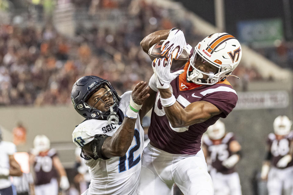 Virginia Tech's Kyle Lane, right, makes a catch against Old Dominion's Tahj Ra-El (12) during the first half of an NCAA college football Saturday, Sept. 2, 2023, in Blacksburg, Va. (AP Photo/Robert Simmons)