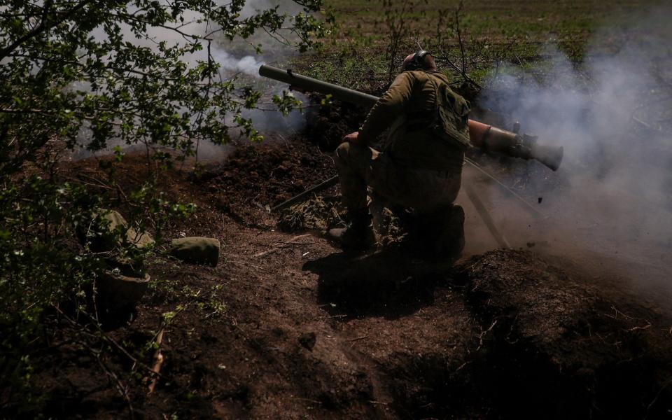 A Ukrainian service member from a 28th separate mechanised brigade named after the Knights of the Winter Campaign of the Armed Forces of Ukraine, fires an anti-tank grenade launcher at a front line, - Sofiia Gatilova/REUTERS