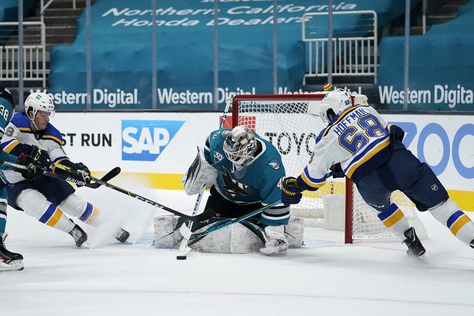 San Jose Sharks goaltender Devan Dubnyk (40) blocks a shot as St. Louis Blues left wing Mike Hoffman (68) and left wing Sammy Blais, left, attack during the second period of an NHL hockey game in San Jose, Calif., Saturday, Feb, 27, 2021. (AP Photo/Tony Avelar)