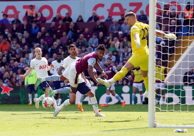 Ollie Watkins, centre, dives as the ball runs wide of the Tottenham goal