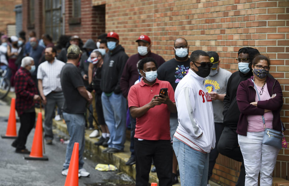 People stand in line to get COVID-19 vaccines. At the site of a walk-up COVID-19 vaccine clinic at the St. Joseph's Community Campus in downtown Reading Wednesday afternoon April 21, 2021. (Ben Hasty/MediaNews Group/Reading Eagle via Getty Images)