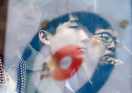 Curling - Pyeongchang 2018 Winter Olympics - Men's Round Robin - Gangneung Curling Center - Gangneung, South Korea - February 20, 2018 - spectators are reflected in the glass barrier as they watch the curling games. REUTERS/Cathal McNaughton