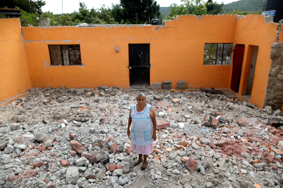 <p>Ventura Sanchez, 63, housewife, poses for a portrait on the rubble of her house after an earthquake in La Nopalera, Mexico, September 27, 2017. The house was badly damaged but with the help of her family Ventura rescued some furniture. She is living in her backyard and hopes for her house to be rebuilt. “I hope the authorities do not deceive us with promises. I am very sad,” she said. (Photo: Edgard Garrido/Reuters) </p>