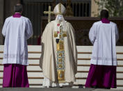 Pope Francis, center, arrives to celebrate an Easter Sunday Mass in St. Peter's Square at the Vatican Sunday, April 20, 2014. Francis is celebrating Christianity's most joyous day, Easter Sunday, under sunny skies and before a flock of faithful who brimmed over from a flower-bedecked St. Peter's Square. (AP Photo/Andrew Medichini)