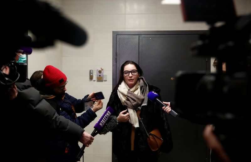 Lawyer Veronika Polyakova speaks to the media as she stands next to an apartment of Russian opposition leader Alexei Navalny in Moscow