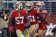 San Francisco 49ers linebacker Dre Greenlaw (57) celebrates after recovering a fumble by New Orleans Saints running back Alvin Kamara with teammates linebacker Azeez Al-Shaair (51) and safety George Odum during the second half of an NFL football game in Santa Clara, Calif., Sunday, Nov. 27, 2022. (AP Photo/Jed Jacobsohn)