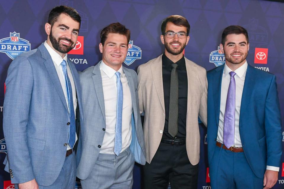 <p>Aaron J. Thornton/Getty</p> Drake Maye (second from left) with his brothers Luke, Beau and Cole