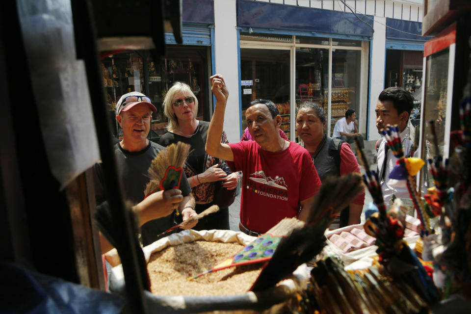 In this May 9, 2019 photo, Apa Sherpa, center, with members of his foundation walk around Boudhanath Stupa in Kathmandu, Nepal. Apa Sherpa has stood on top of the world more times than all but one other person. Now he wants to make sure no one feels compelled to follow in his footsteps. (AP Photo/Niranjan Shrestha)