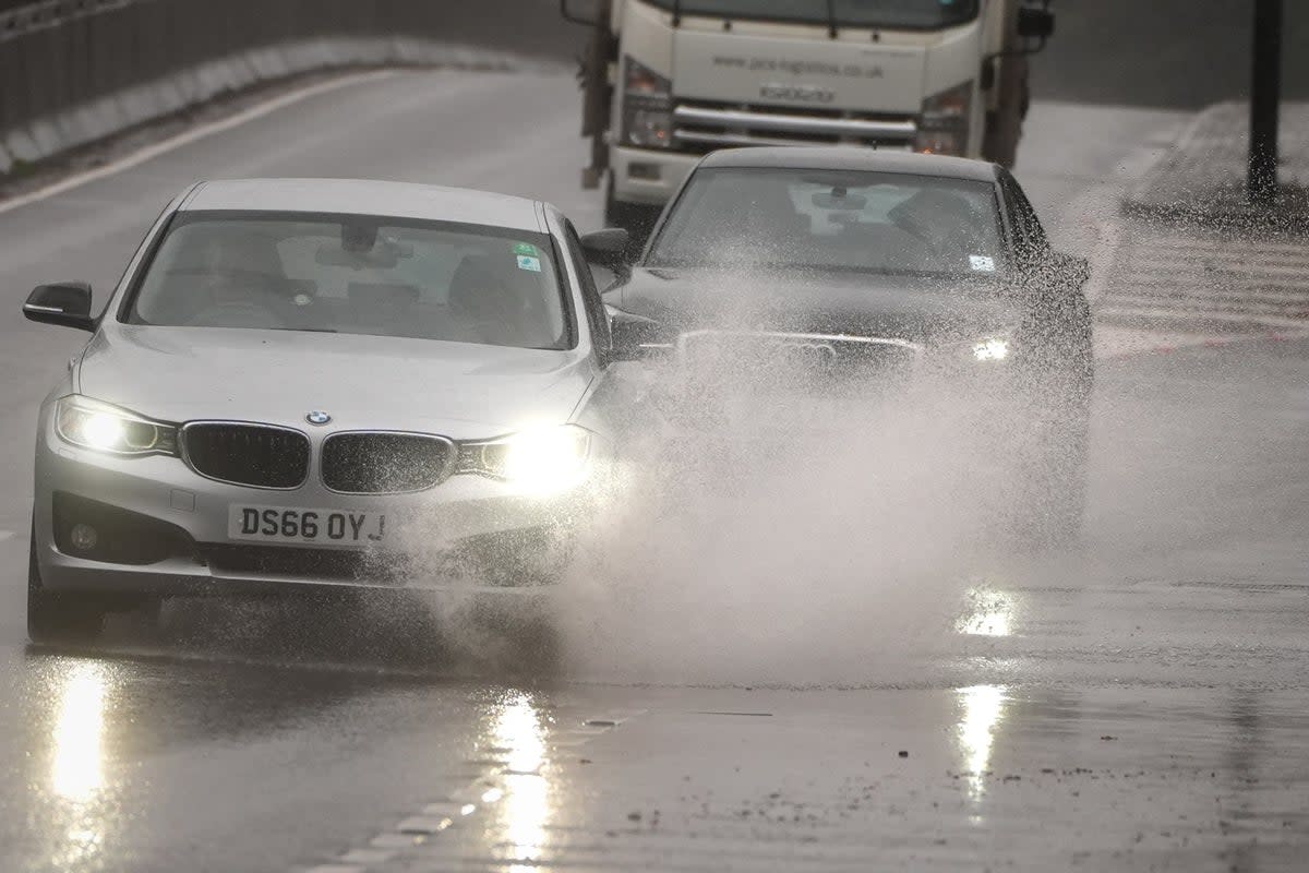 Cars drive through the rain on the A3 (Aaron Chown/PA) (PA Wire)