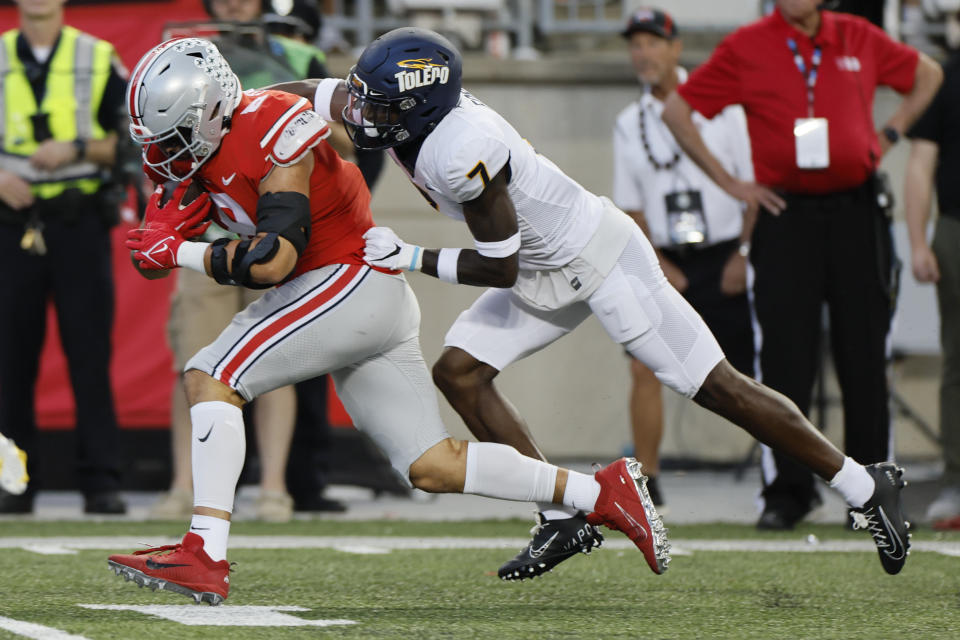 Toledo defensive back Zachary Ford, right, tackles Ohio State tight end Cade Stover during the first half of an NCAA college football game Saturday, Sept. 17, 2022, in Columbus, Ohio. (AP Photo/Jay LaPrete)