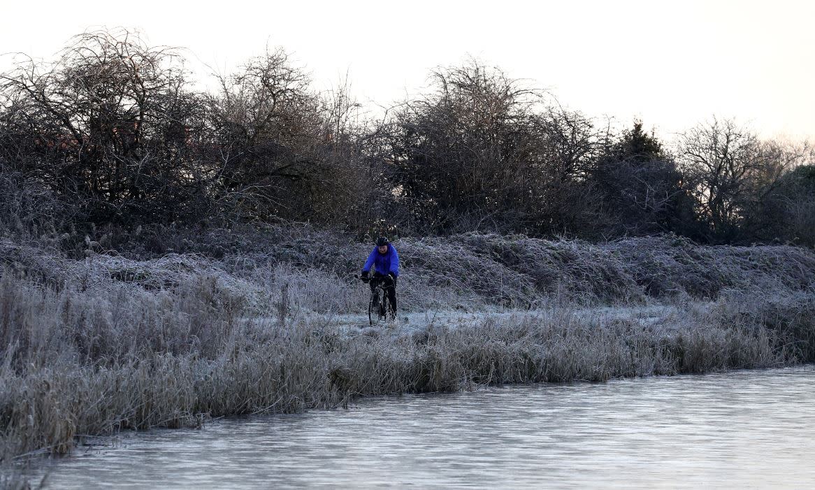 A cyclist enjoys the frost in Scotland this morning (PA)