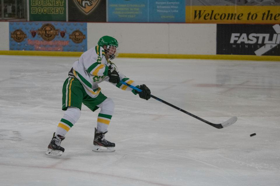 Pueblo County High School's Garrett O'Brien takes a shot on goal during a matchup with Woodland Park at the Pueblo Ice Arena in December 2021.