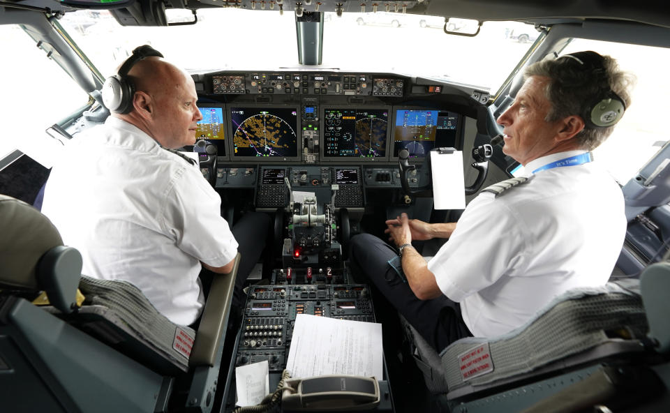 CORRECTS SPELLING OF FIRST NAME TO PETE, NOT PET - American Airlines pilots captain Pete Gamble, left, and first officer John Konstanzer chat in the cockpit of a Boeing 737 Max jet before taking off from Dallas Fort Worth airport in Grapevine, Texas, Wednesday, Dec. 2, 2020. American Airlines took its long-grounded Boeing 737 Max jets out of storage, updating key flight-control software, and flying the planes in preparation for the first flights with paying passengers later this month. (AP Photo/LM Otero)