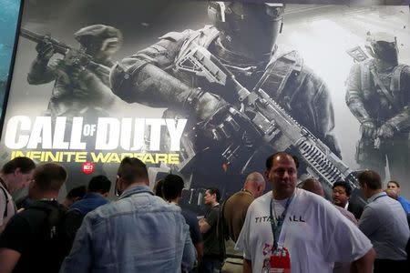 Men line up to play Infinity Ward's "Call of Duty: Infinite Warfare" at the E3 Electronic Expo in Los Angeles, California, U.S. June 14, 2016. REUTERS/Lucy Nicholson/Files