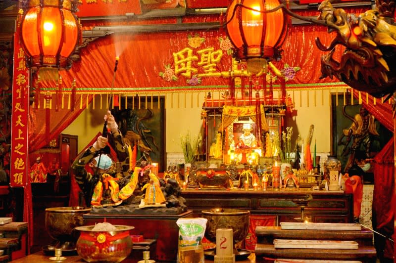 A worker spray disinfectant in a temple, to prevent the spread of coronavirus disease (COVID-19)