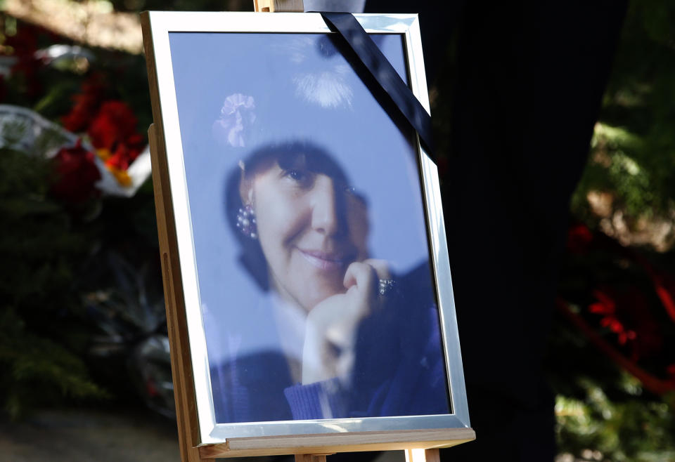 A reflection of a man in the picture of Mirjana Markovic, the widow of former strongman Slobodan Milosevic during her funeral at the yard of his estate in his home town of Pozarevac, Serbia, Saturday, April 20, 2019. Markovic died last week in Russia where she had been granted asylum. The ex-Serbian first lady had fled there in 2003 after Milosevic was ousted from power in a popular revolt and handed over to the tribunal in The Hague, Netherlands. (AP Photo/Darko Vojinovic)