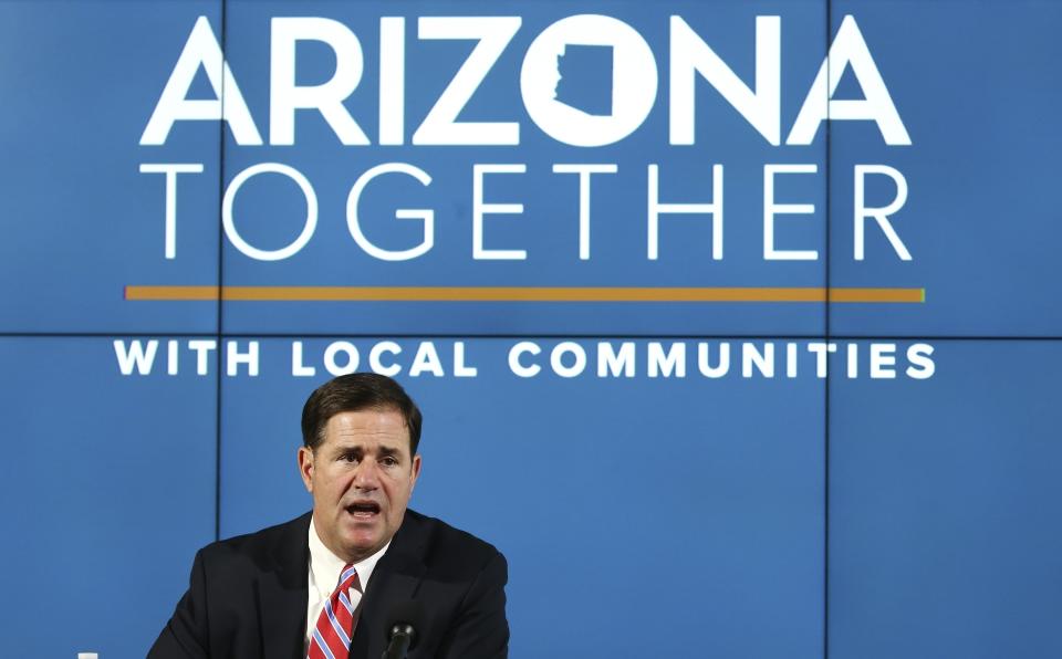 FILE - In this Thursday, May 28, 2020, file photo, Arizona Republican Gov. Doug Ducey speaks about the most recent Arizona coronavirus data at a news conference in Phoenix. Many states have yet to spend the federal funding they got more than a month ago to help with soaring costs related to the coronavirus crisis, making it tougher for states and cities to argue that they need hundreds of billions more from U.S. taxpayers. Ducey said he’s giving local governments leeway on how they spend their allocations from the state. (AP Photo/Ross D. Franklin, Pool, File)