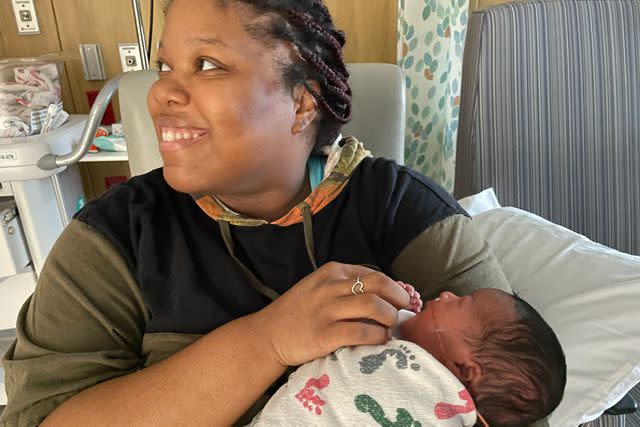 <p>Cone Health</p> Angelia Tutt holds one of her newborns