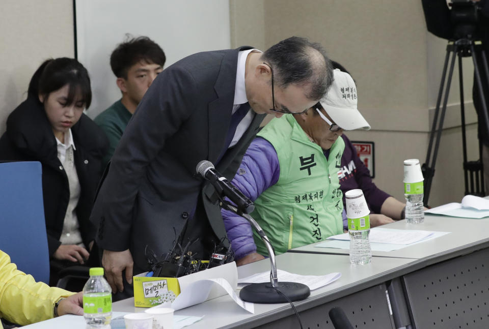 South Korea's Prosecutor General Moon Moo-il bows in apology in Seoul, South Korea, Tuesday, Nov. 27, 2018. Moon apologized over what he described as a botched investigation into the enslavement and mistreatment of thousands of people at a vagrants' facility in the 1970s and 1980s nearly three decades after its owner was acquitted of serious charges. (AP Photo/Lee Jin-man)