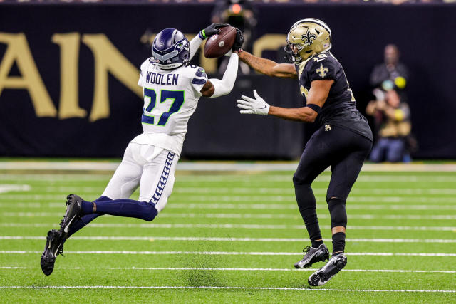 Oct 9, 2022; New Orleans, Louisiana, USA; Seattle Seahawks cornerback Tariq Woolen (27) intercepts a pass from New Orleans Saints quarterback Andy Dalton (14) going to wide receiver Tre'Quan Smith (10) during the second half at Caesars Superdome. Mandatory Credit: Stephen Lew-USA TODAY Sports