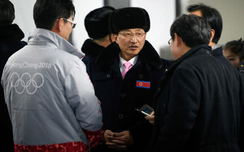 Won Kil-u, North Korea's Vice Minister of Physical Culture and Sports and leader of the North Korean delegation, is greeted as the team arrive at the athletes village in Gangneung - Credit:  Getty Images