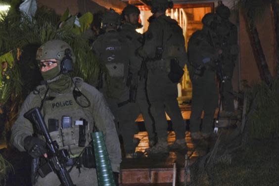 DEA agents search a residential house during an arrest of a suspected drug trafficker on 11 March, 2020 in Diamond Bar, California as part of Project Python, aimed at dismantling the Jalisco New Generation Cartel, known as CJNG. (AP Photo/Richard Vogel)