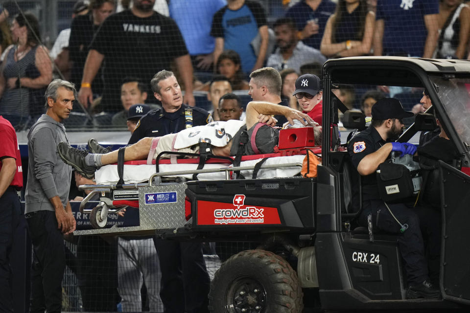 A camera operator who was injured on a throwing error by Baltimore Orioles' Gunnar Henderson has ben placed on a cart during the fifth inning of the Orioles' baseball game against the New York Yankees on Wednesday, July 5, 2023, in New York. (AP Photo/Frank Franklin II)