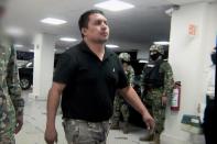 A picture taken from a video released by the Mexican Navy showing alleged leader of "Los Zetas", Miguel Angel Trevino Morales, aka "El Z 40" escorted by marines in Mexico City on July 16, 2013