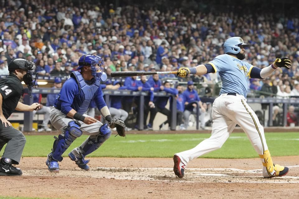 Milwaukee Brewers' Carlos Santana hits a two-run scoring triple during the fifth inning of a baseball game against the Chicago Cubs Friday, Sept. 29, 2023, in Milwaukee. (AP Photo/Morry Gash)