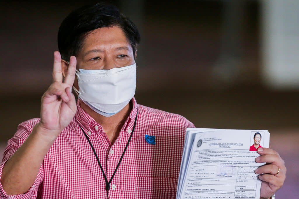 Former senator Ferdinand ‘Bongbong’ Marcos Jr poses after filing his certificate of candidacy (AP)