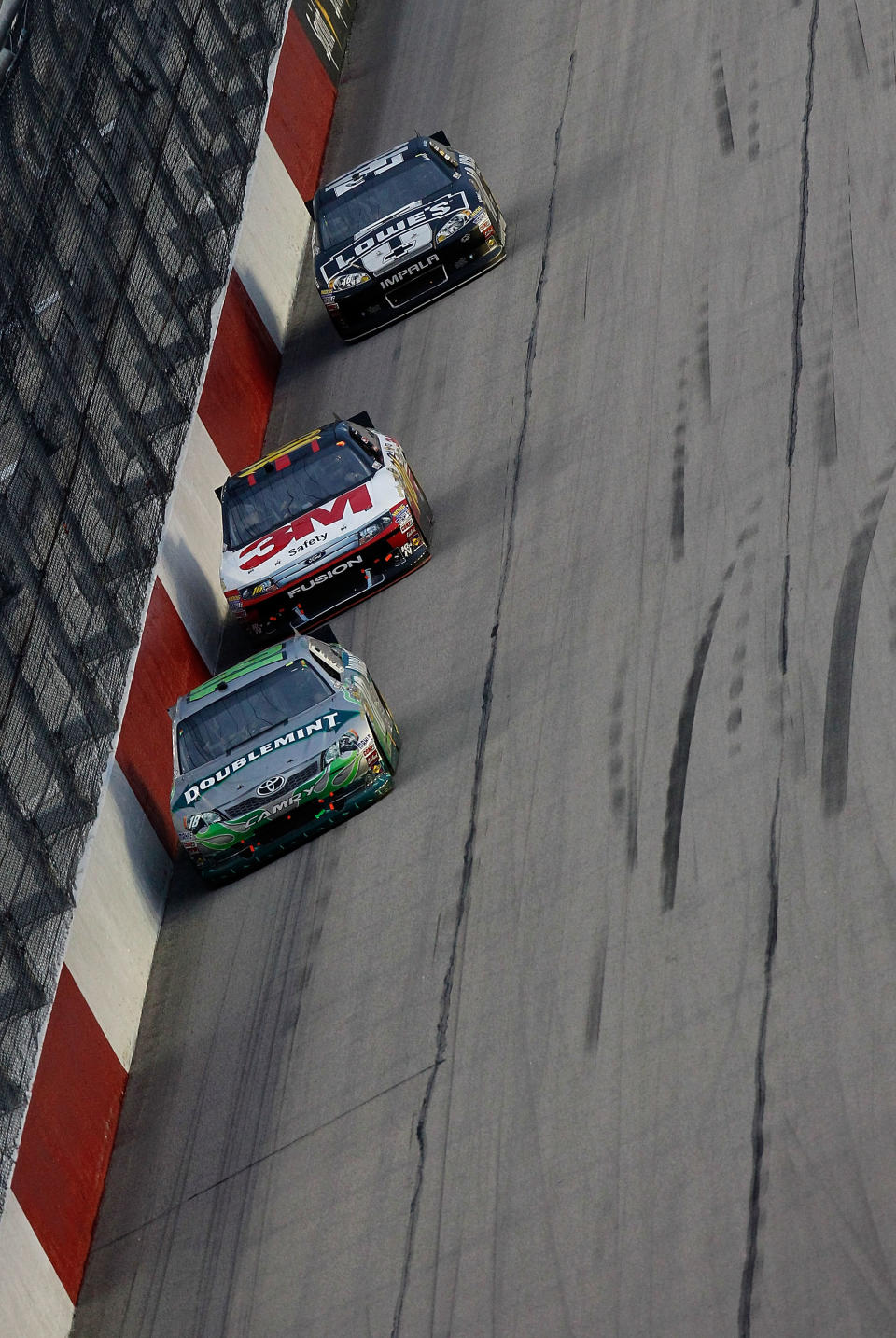 DARLINGTON, SC - MAY 12: Kyle Busch, driver of the #18 Wrigley Toyota, leads Greg Biffle, driver of the #16 3M/OH/ES Ford, and Jimmie Johnson, driver of the #48 Lowe's/Kobalt Tools Chevrolet, during the NASCAR Sprint Cup Series Bojangles' Southern 500 at Darlington Raceway on May 12, 2012 in Darlington, South Carolina. (Photo by Jeff Zelevansky/Getty Images for NASCAR)