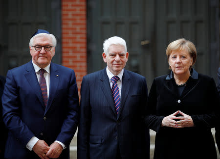German Chancellor Angela Merkel, President Frank-Walter Steinmeier and President of the Central Council of Jews in Germany Josef Schuster pose before taking part in a ceremony to mark the 80th anniversary of Kristallnacht, also known as Night of Broken Glass, at Rykestrasse Synagogue, in Berlin, Germany, November 9, 2018. REUTERS/Axel Schmidt