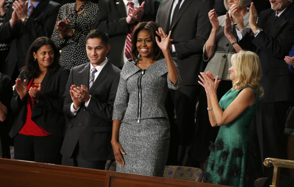 U.S. first lady Michelle Obama waves prior to President Obama's State of the Union address to a joint session of Congress on Capitol Hill in Washington