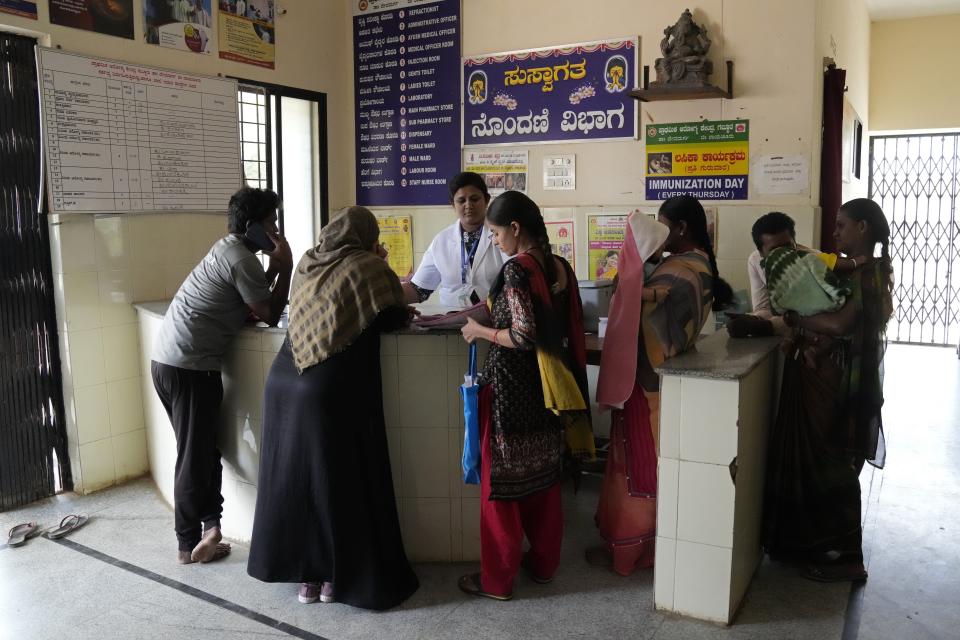 A nurse attends to the patients at a health care center which runs on rooftop solar power, near Raichur, India, Thursday, April 20, 2023. Government Maternity installed rooftop solar panels about a year ago and can now depend on constant electricity that keeps the lights on, patients and staff comfortable and vaccines and medicines safely refrigerated. (AP Photo/Aijaz Rahi)